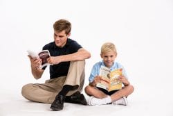 A Great Hearted Leader reading a book with a young learner