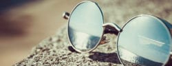 A pair of glasses in front of water