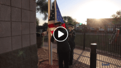 A dedication ceremony at a flagpole