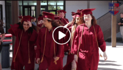 Seniors walk in their graduation gear