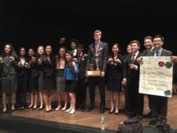 Winners of a speech and debate contest stand on stage