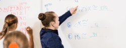 Girl at whiteboard doing math
