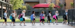 Archway Cicero students walking into school with backpacks