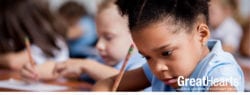 young girl at desk writing