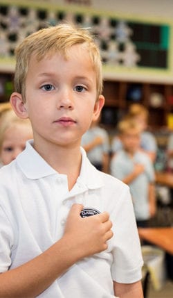 Young boy recites the Pledge of Allegiance at Great Hearts Classical Academies.