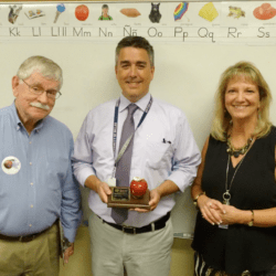 teacher receives an apple trophy