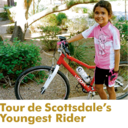 Young girl standing in front of bike