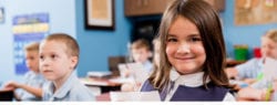 young girl sitting at desk