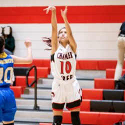 Justine Cooper shoots a basketball