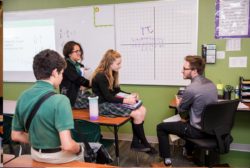 male teacher doing math with students