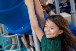 female student playing on playground