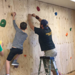 building a rock climbing wall inside archway trivium east