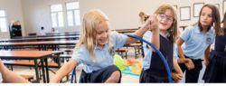 students playing with a hula hoop