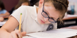 girl writing at desk