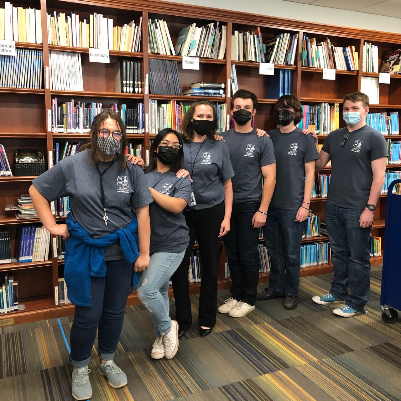 students standing in library