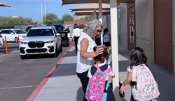 Mrs. Benham greeting students in drop-off line