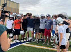 Scottsdale Coach posing with his football team