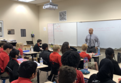 Pierre Marcos teaching in classroom