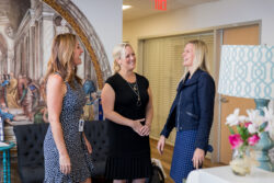 Three adults speaking in an office