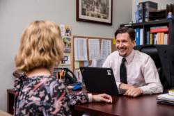 Two adults speaking in an office