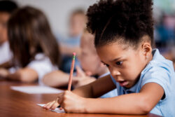 Young girl writing at her desk