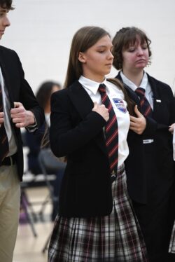 Students putting on blazer at Blazer Ceremony