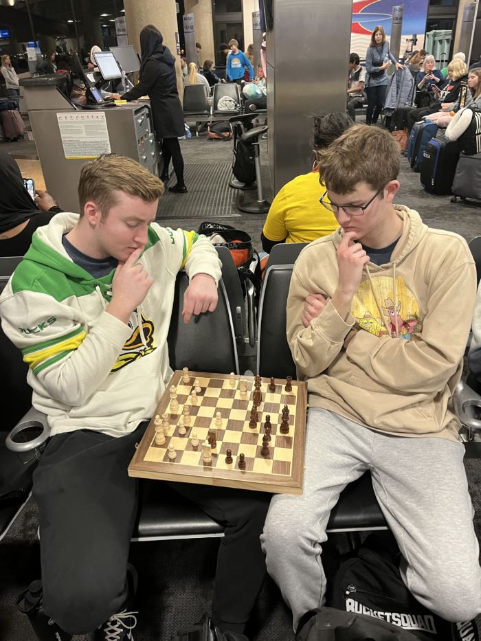 Seniors playing chess in the airport