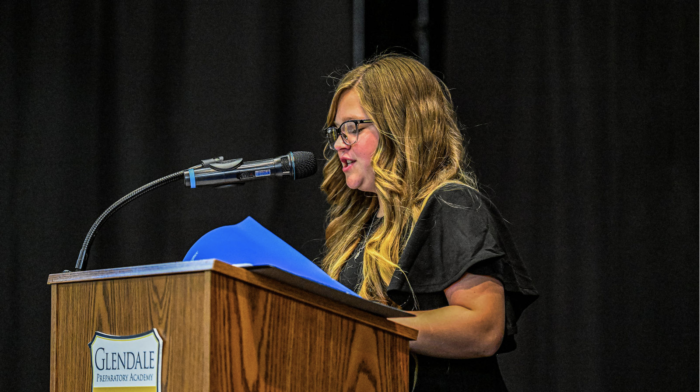 Student giving speech on a virtue at 5th grade promotion ceremony