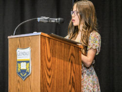 Student giving speech on a virtue at 5th grade promotion ceremony