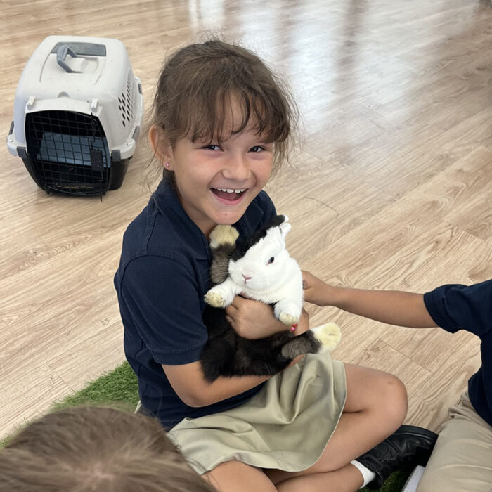 Student holding a rabbit