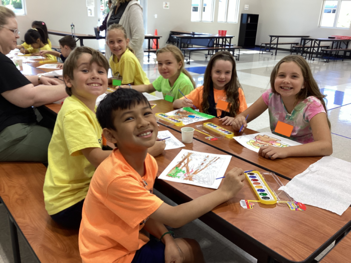Summer Camp students doing water colors at a table