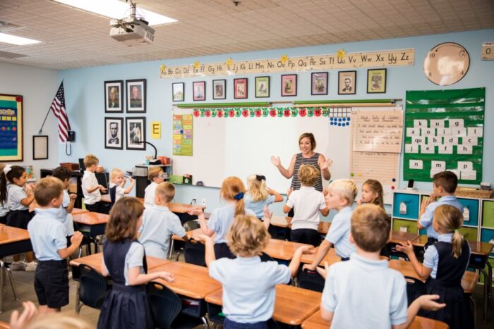 Kindergarten classroom with children facing teacher up front.