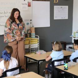 Teacher giving instructions to a classroom of students