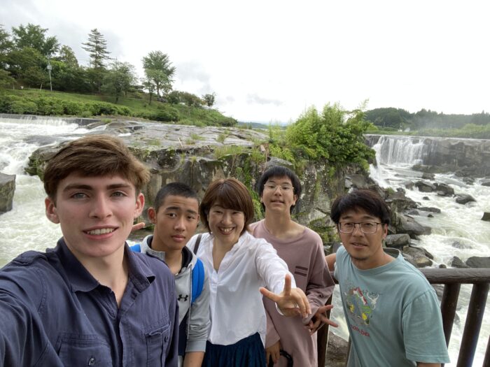 Student visiting waterfall with host family in Isa City.