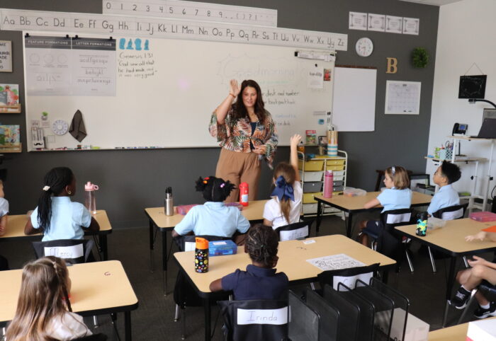 Teacher giving instructions to a classroom of students