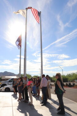 crowd around flagpoles