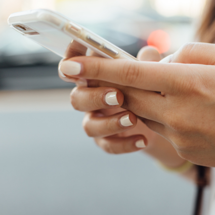 Teenage girl holding smart phone