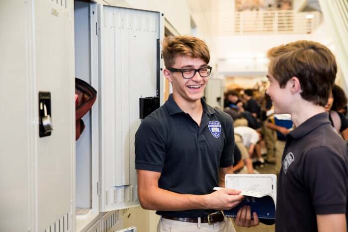Two high school boys at a locker