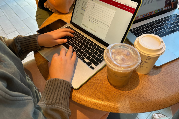 High school senior on laptop in a coffee shop