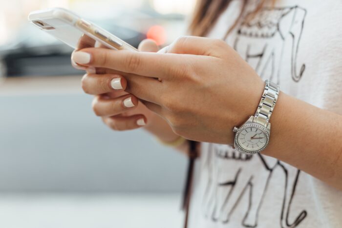 Teen girl holding smart phone