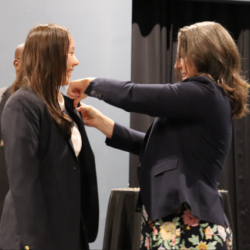 Headmaster pinning a student at Blazer Ceremony