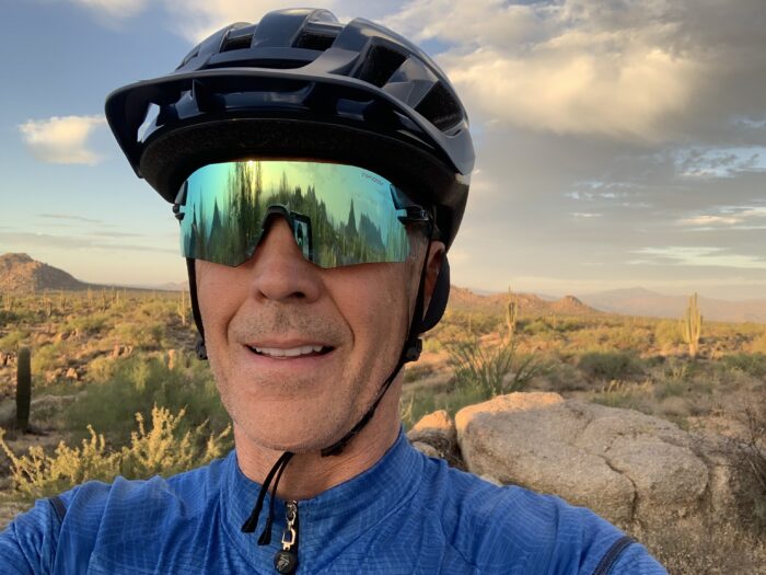 Teacher in mountain bike gear in desert terrain.