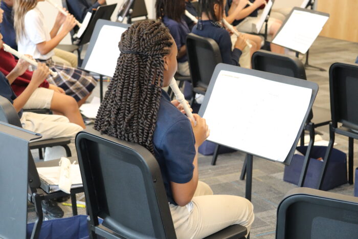 student playing recorder at Harveston