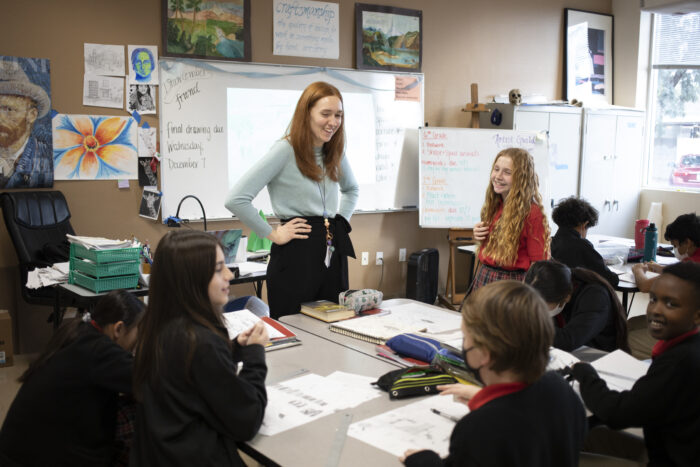 Teacher laughing with students