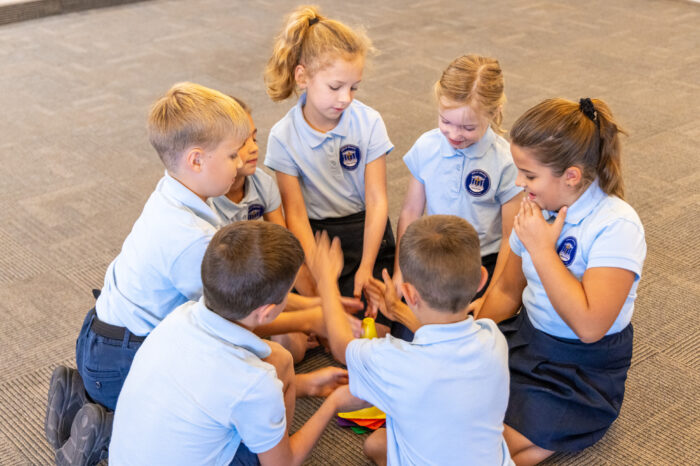 Group of Great Hearts Christos students in a circle playing a game