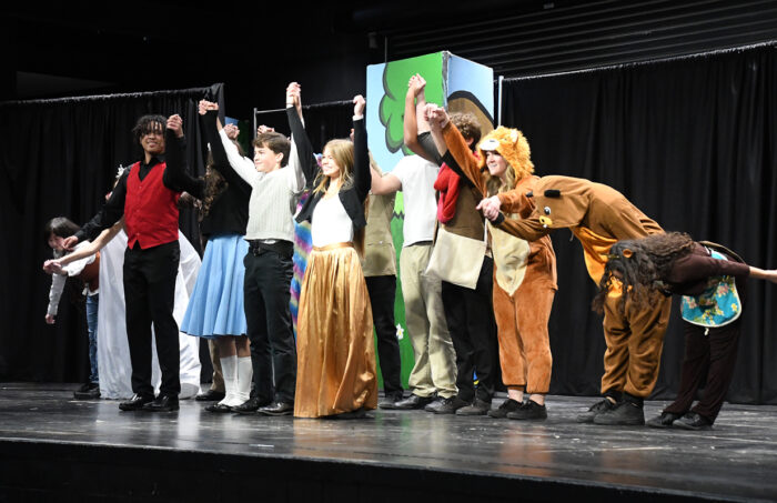 Trivium seniors performing "The Lion, The Witch and the Wardrobe" on stage.