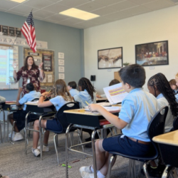 Ms. Rogers teaching in front of classroom