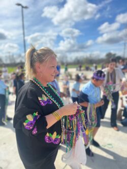 Teacher at Great Hearts Harveston Mardi Gras parade.