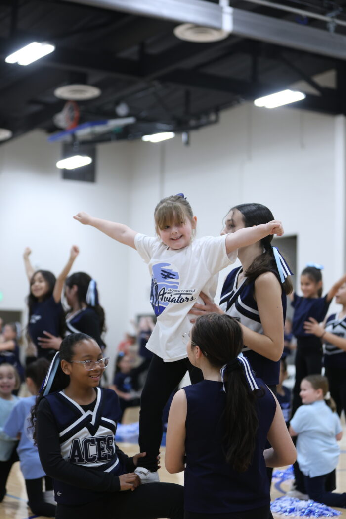 Members of the Great Hearts Roosevelt Spirit Squad doing a stunt