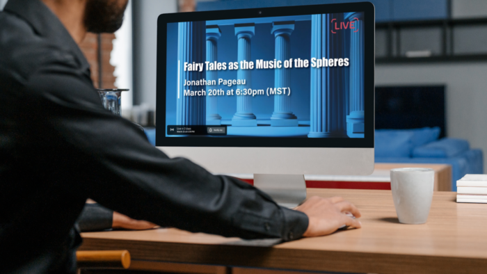 Man watching livestream of Symposium on his computer.